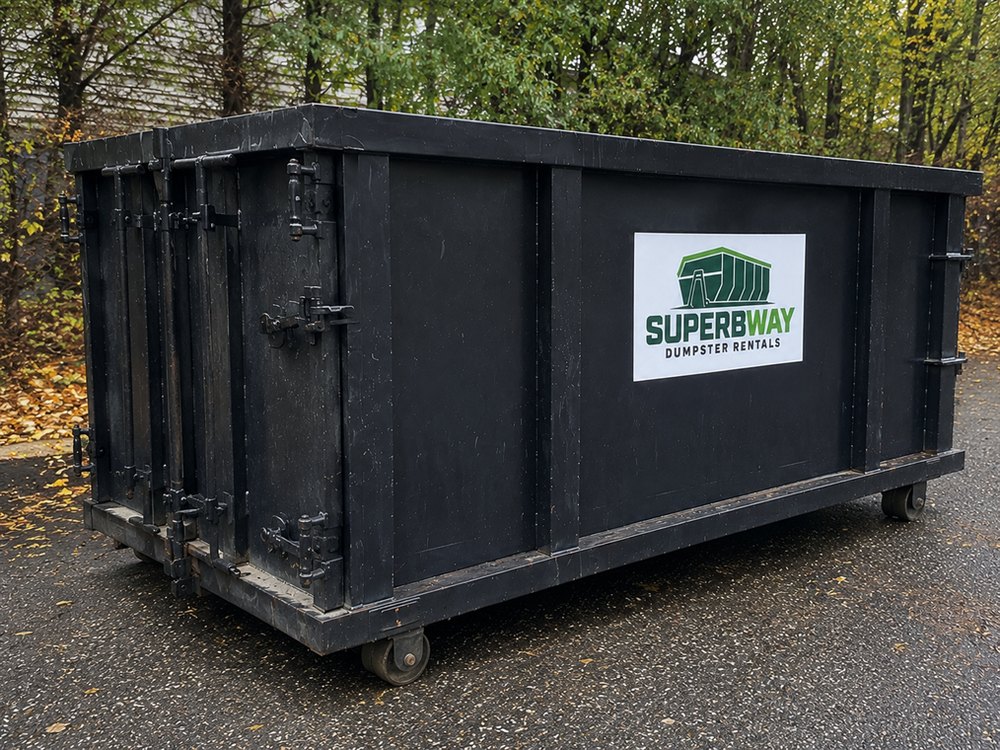 Black Superbway roll-off container in use on a contractor jobsite